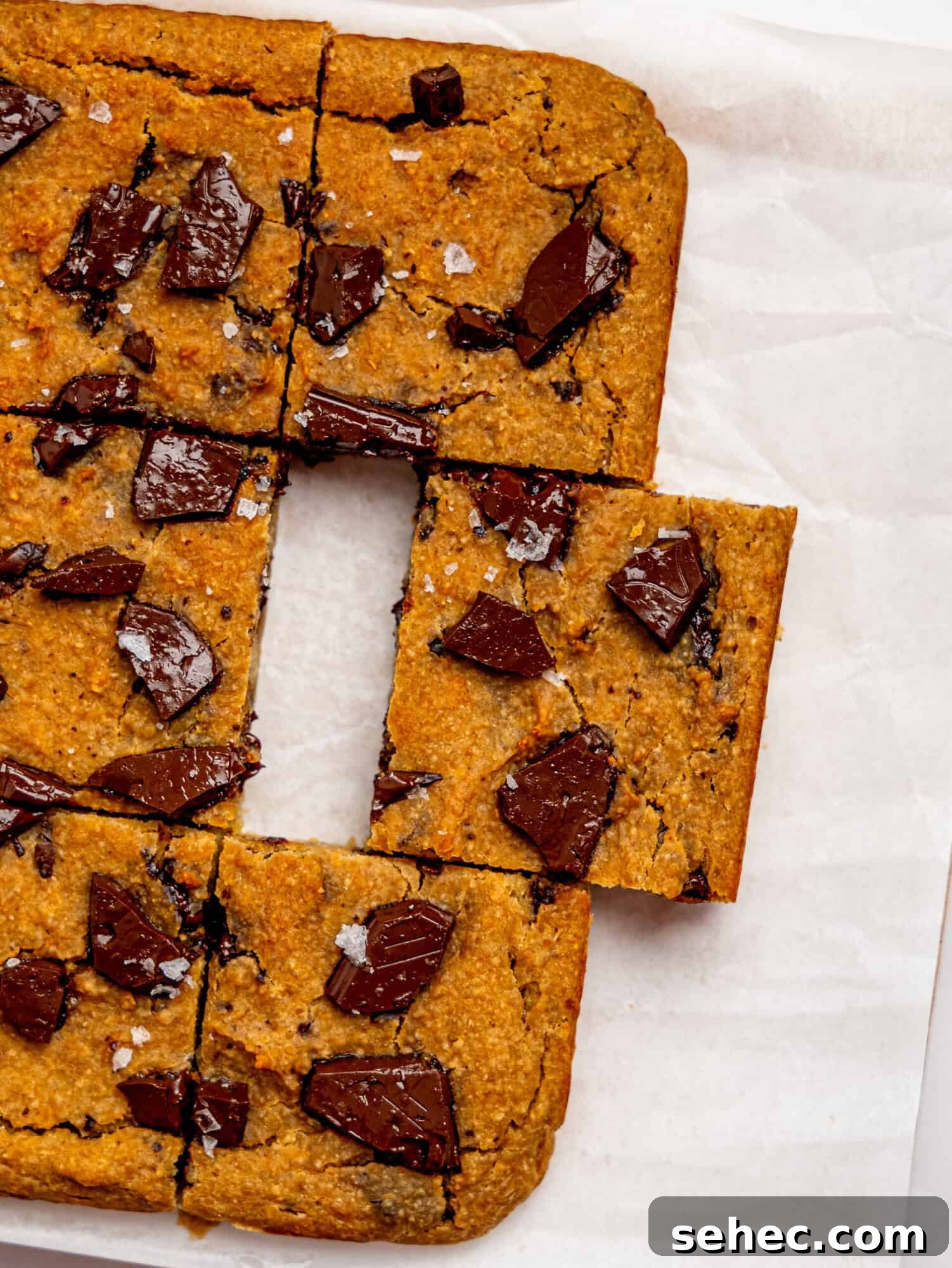 Gooey Chickpea Cookie Bars 3 Bird's eye view of healthy cookie bars on a sheet of white parchment paper.