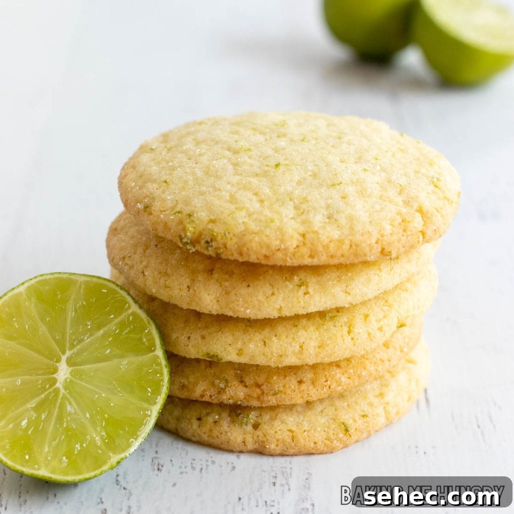 Soft Lime Sugar Cookies with Zesty Citrus Glaze 2 lime sugar cookies in a stack next to halved lime