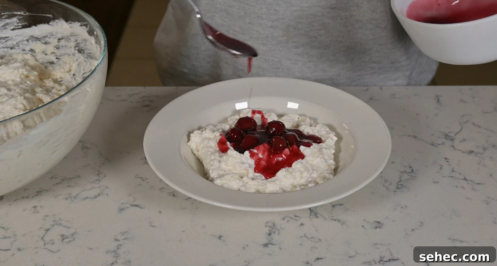 Risalamande Danish Rice Pudding with Almonds 17 Adding cherry sauce to rice pudding.