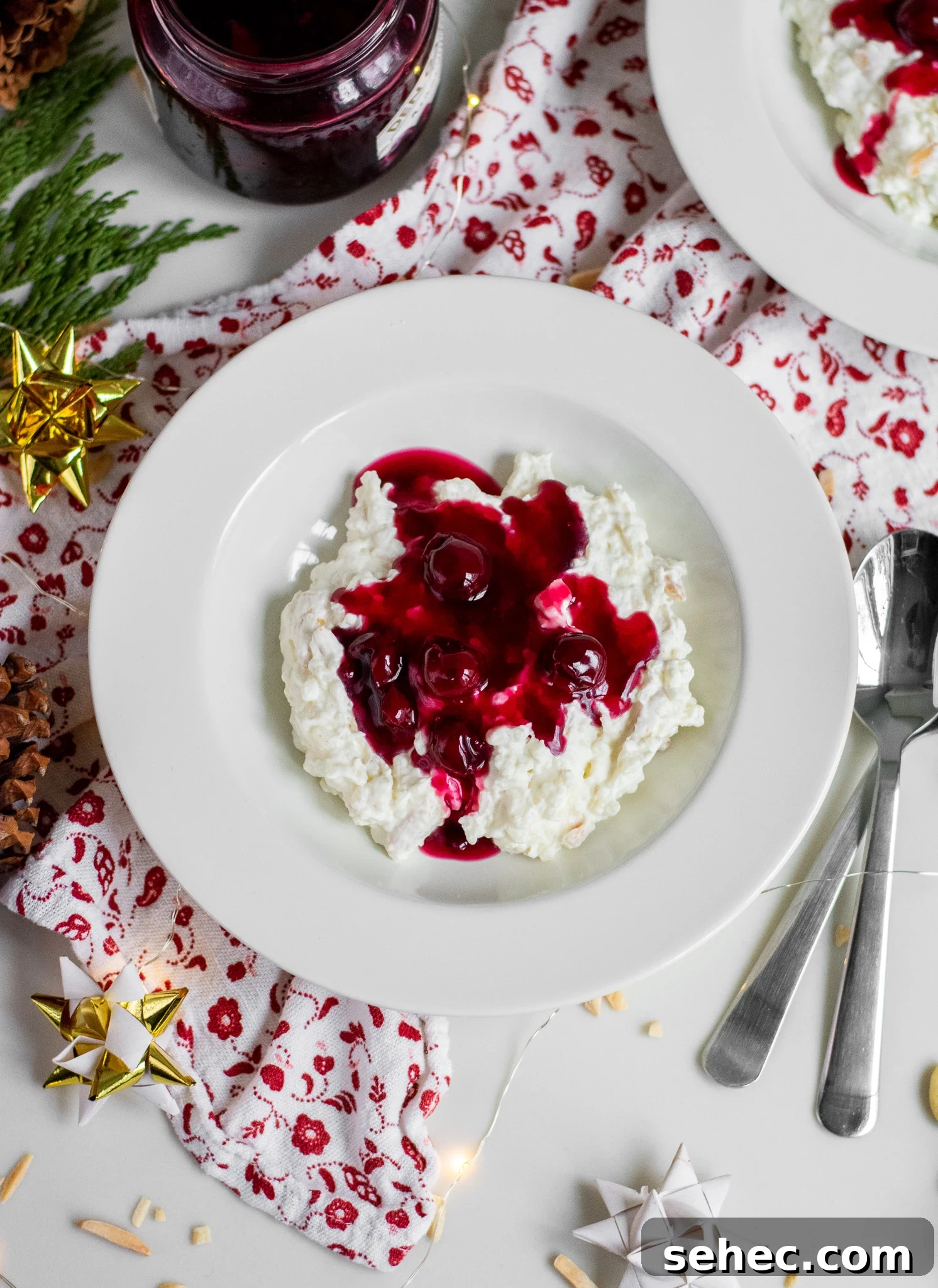 Risalamande Danish Rice Pudding with Almonds 3 Rice porridge with cherry sauce in a bowl.
