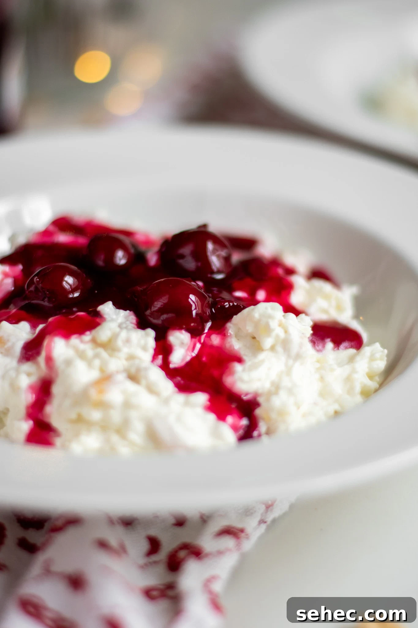 Risalamande Danish Rice Pudding with Almonds 5 Rice porridge with cherry sauce in a bowl.