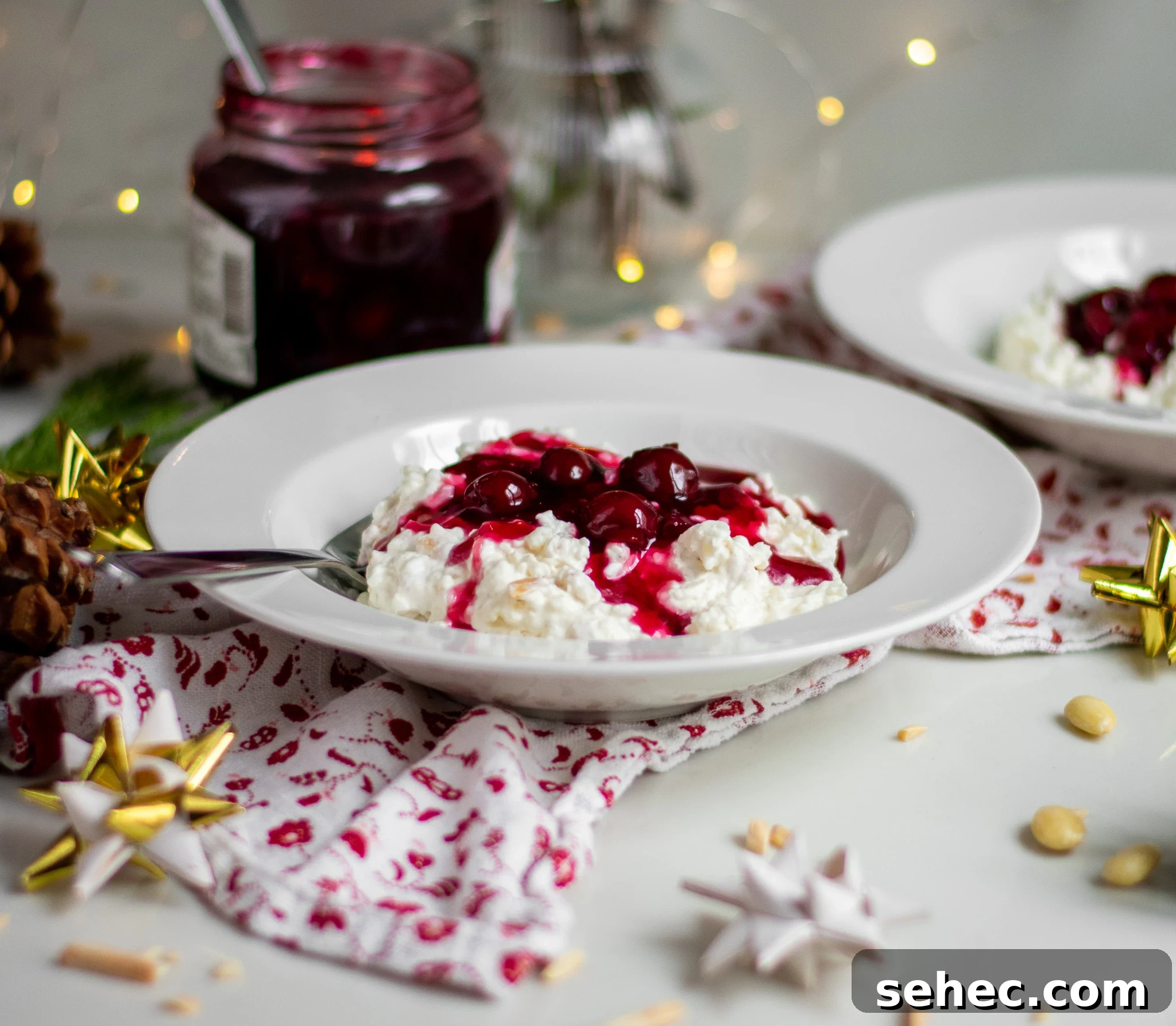 Risalamande Danish Rice Pudding with Almonds 6 Rice porridge with cherry sauce in a bowl.