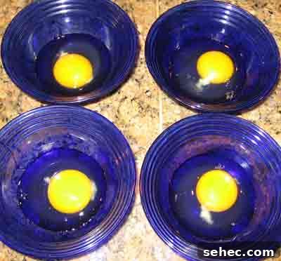 How to Fry Eggs Like a Greek Mom 2 Cracking the eggs into bowls for Greek recipe for fried eggs.