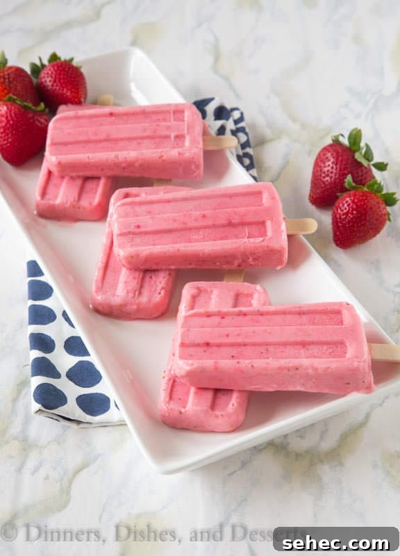 Strawberry Greek Yogurt Popsicles Recipe 2 strawberry greek yogurt popsicles on a plate