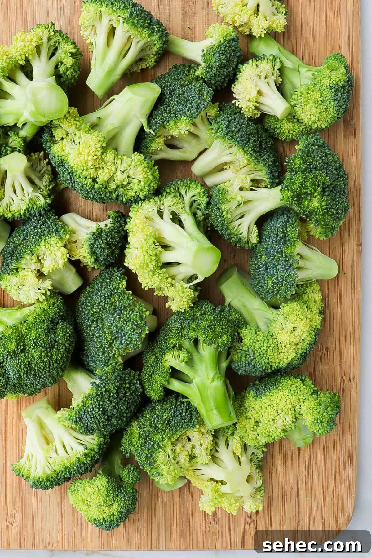 Korean Broccoli Banchan Side Dish Recipe 5 Broccoli florets being cut into pieces.
