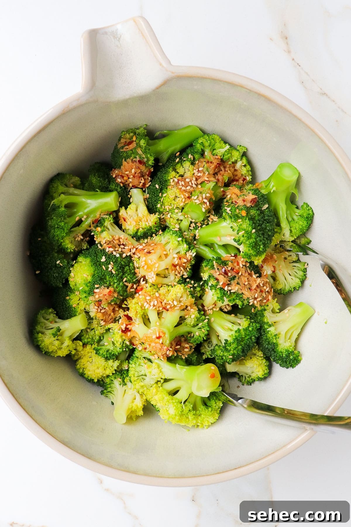 Korean Broccoli Banchan Side Dish Recipe 8 Broccoli being mixed with sesame chilli oil.