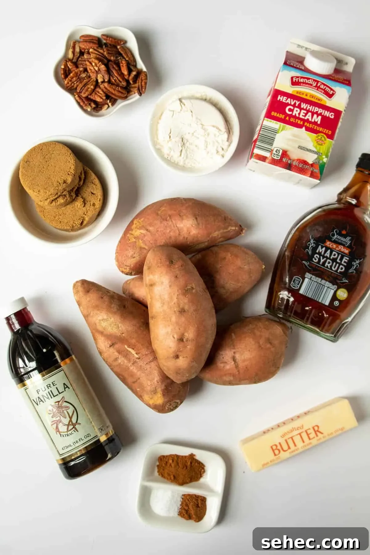 Classic Sweet Potato Casserole with Pecan Topping 4 Ingredients for sweet potato casserole arranged on a white board.