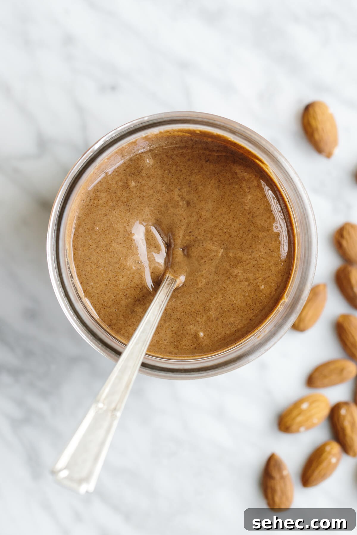 This almond butter recipe is healthy, delicious and super easy to make! Almond butter in a glass jar.