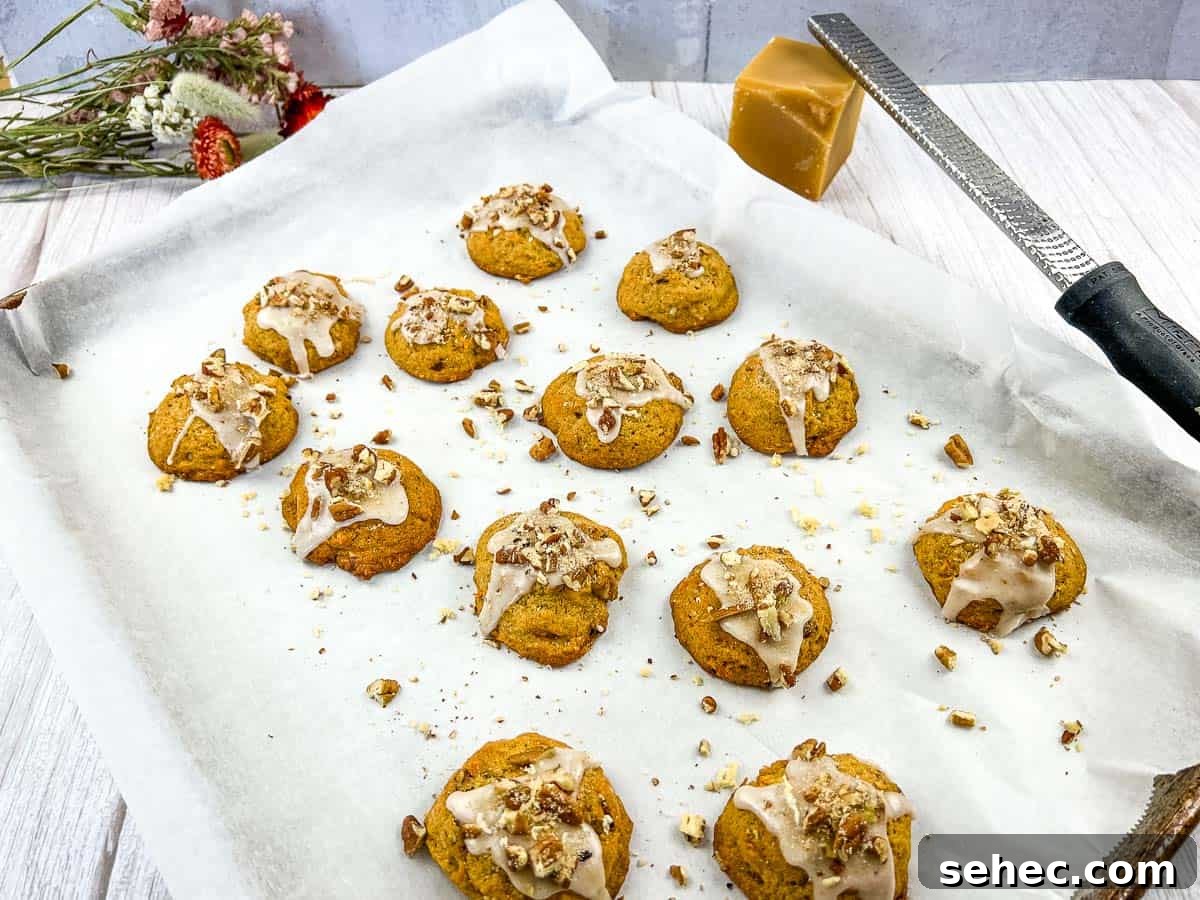 17 Buttery Fall Cookie Recipes for Cozy Shorter Days 11 Sweet Potato Cookies on a baking sheet with icing and nuts.