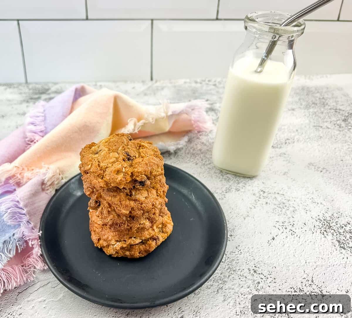 17 Buttery Fall Cookie Recipes for Cozy Shorter Days 7 Oatmeal raisin cookies on a plate next to a glass of milk.