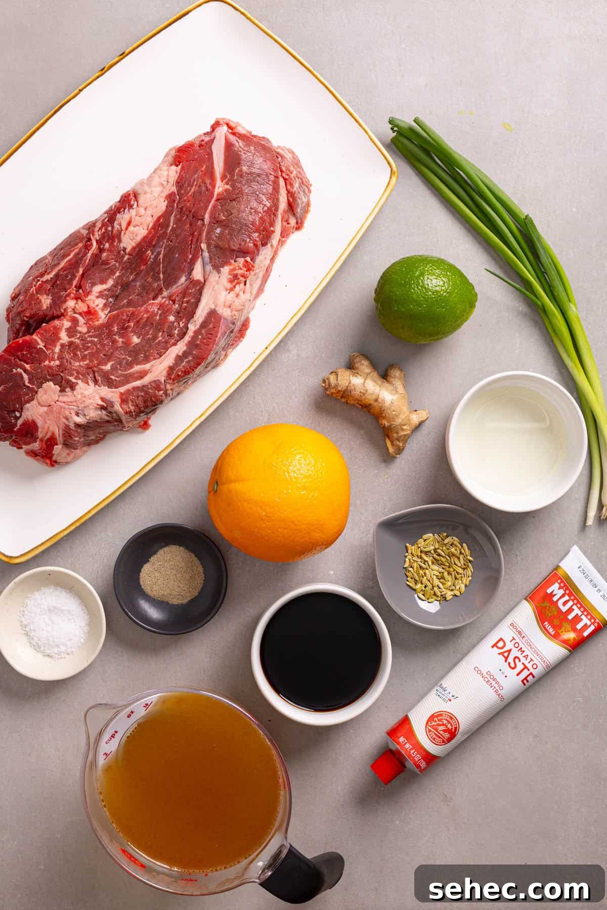 Citrus Soy Braised Chuck Roast Recipe 3 Ingredients for braised chuck roast on a grey table.