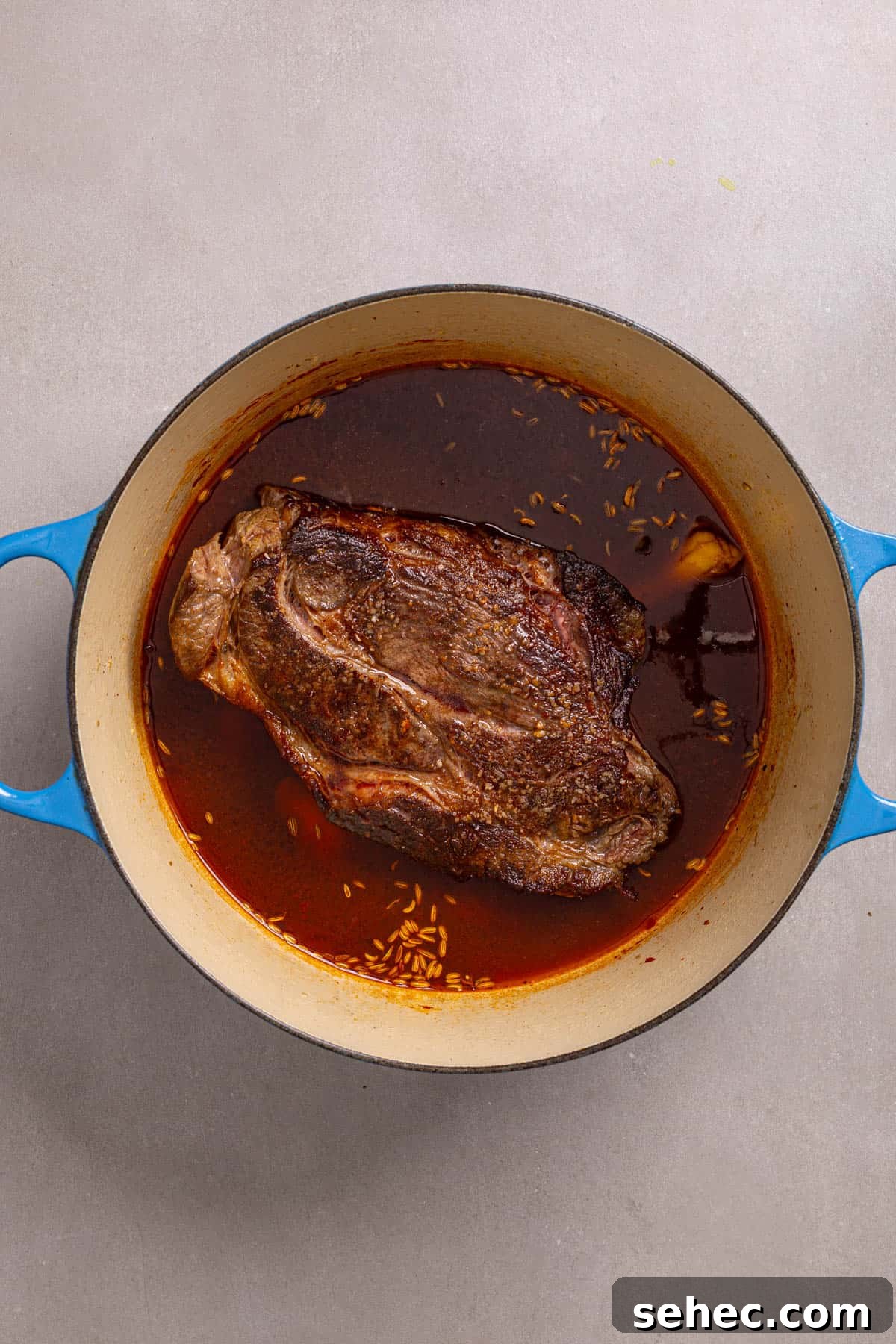 Citrus Soy Braised Chuck Roast Recipe 5 A Dutch oven with a browned chuck roast and braising liquid.