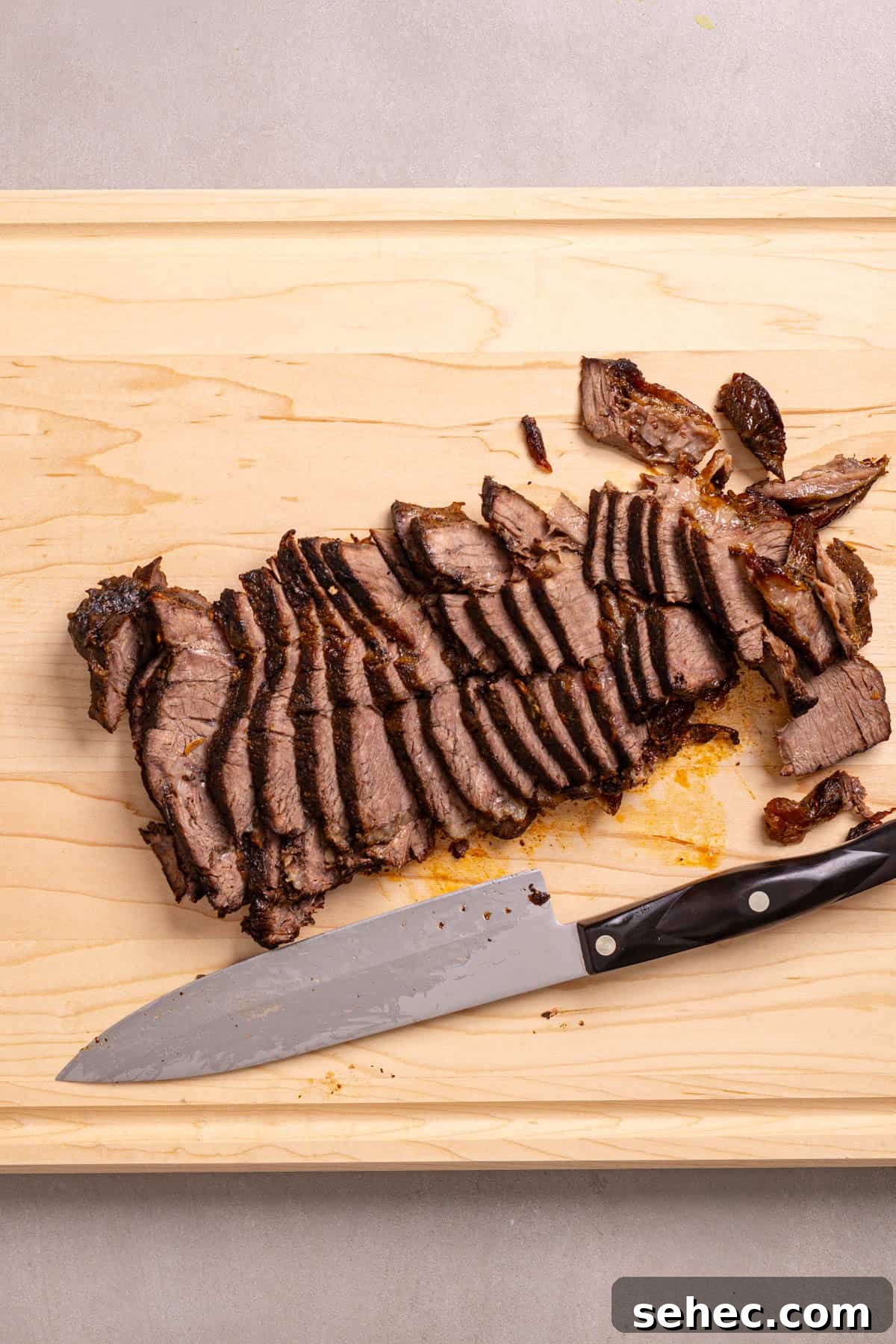 Citrus Soy Braised Chuck Roast Recipe 7 Braised chuck roast on a cutting board thinly sliced.