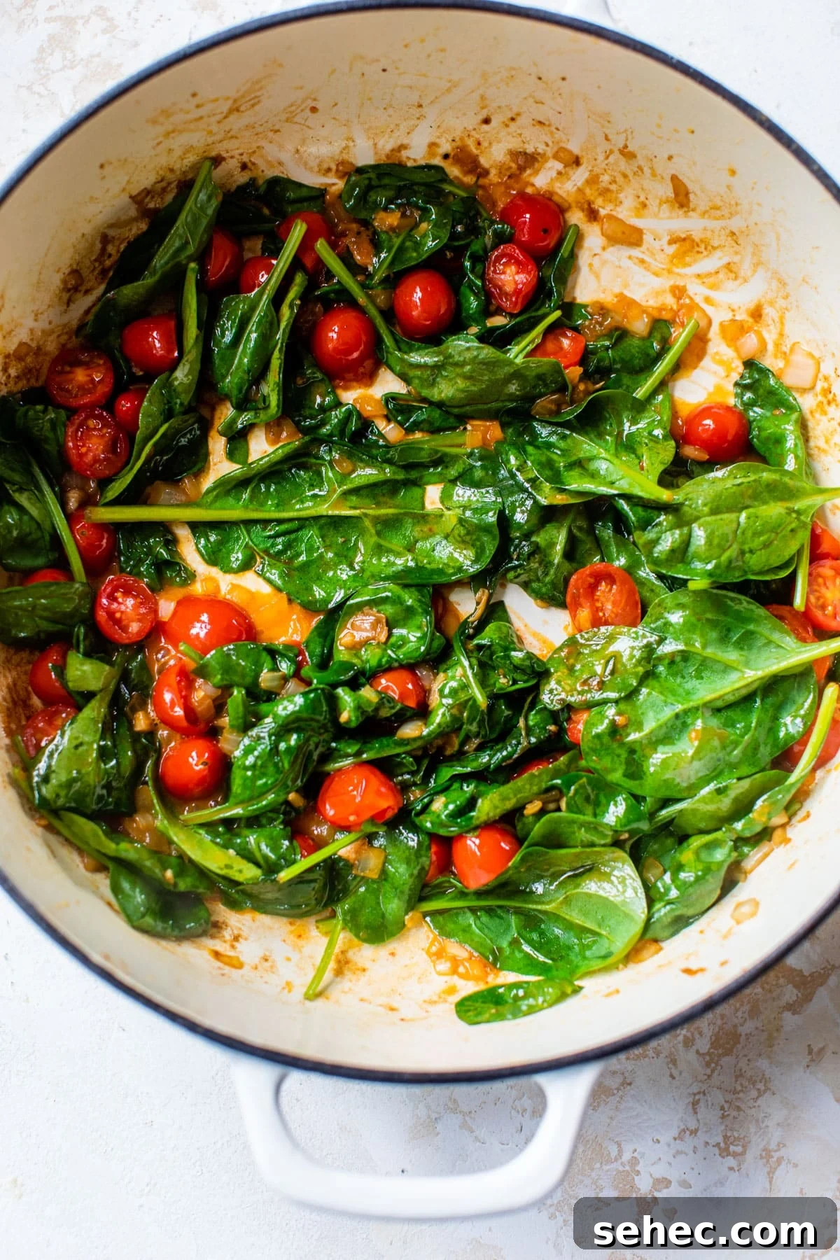 Creamy Chicken Gnocchi Skillet Recipe 5 cooked spinach and tomatoes in a large skillet
