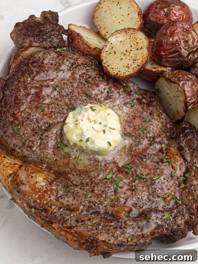 How to Reheat Steak in the Air Fryer 5 ribeye steak with a dollop of butter on the top.