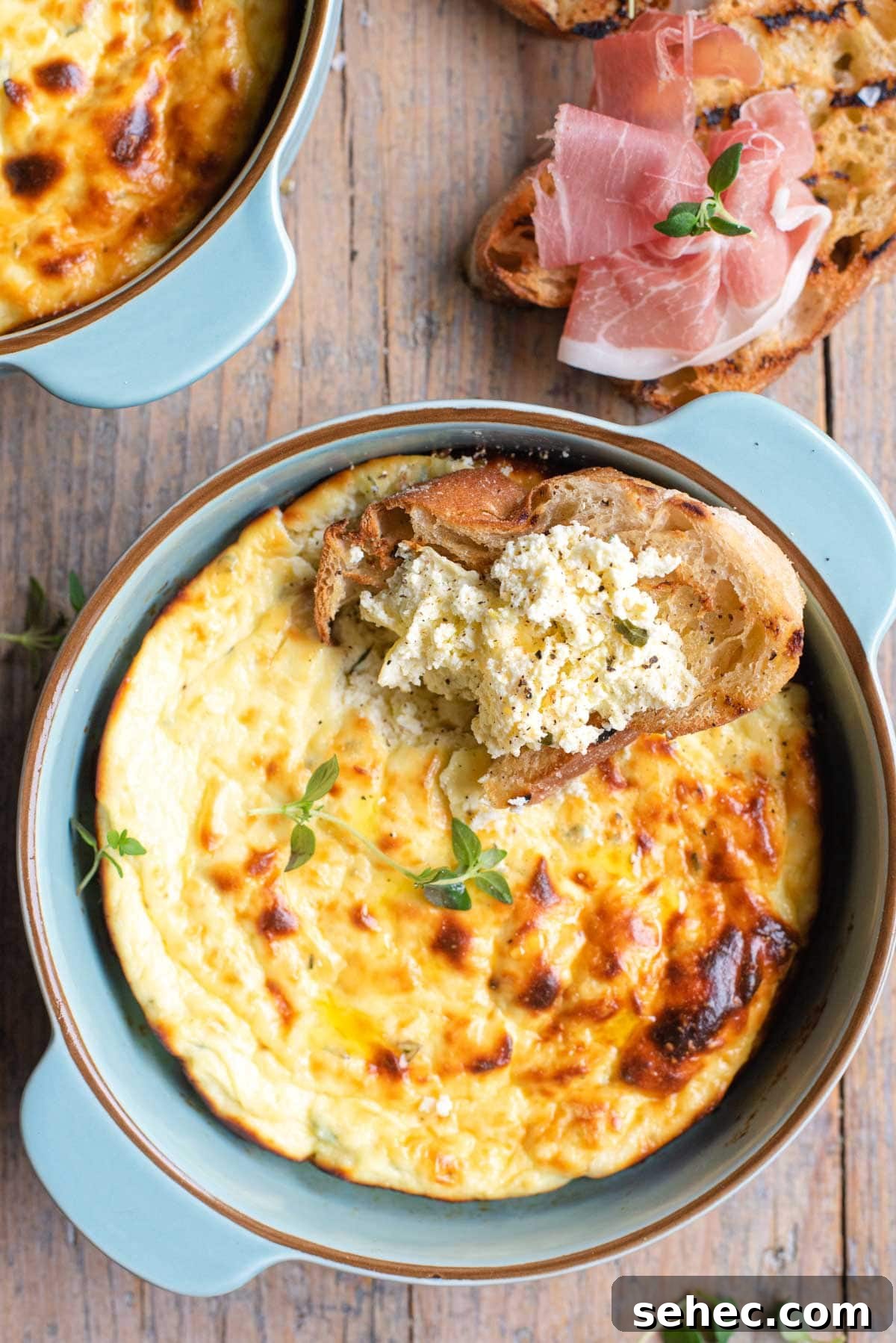 Baked Ricotta Dip with Thyme and Parmesan 6 A close up of baked ricotta in a dish and on some bread