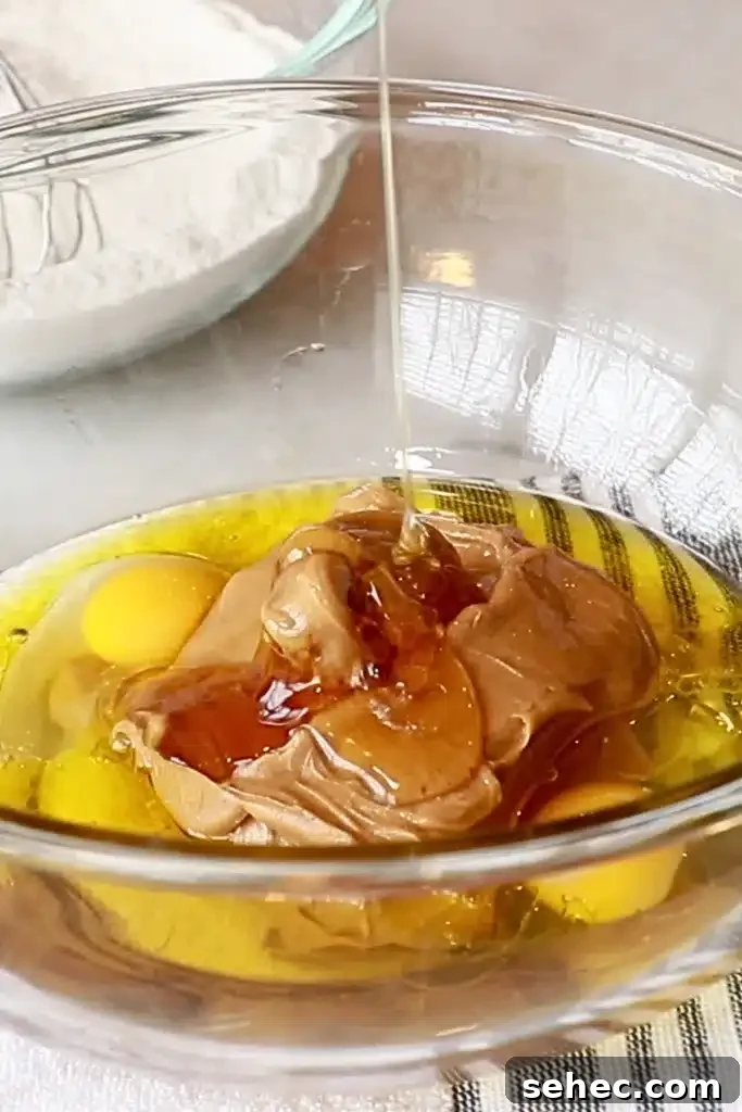 Soft Peanut Butter Chocolate Chip Muffins 7 peanut butter, oil, egg, and honey in a bowl