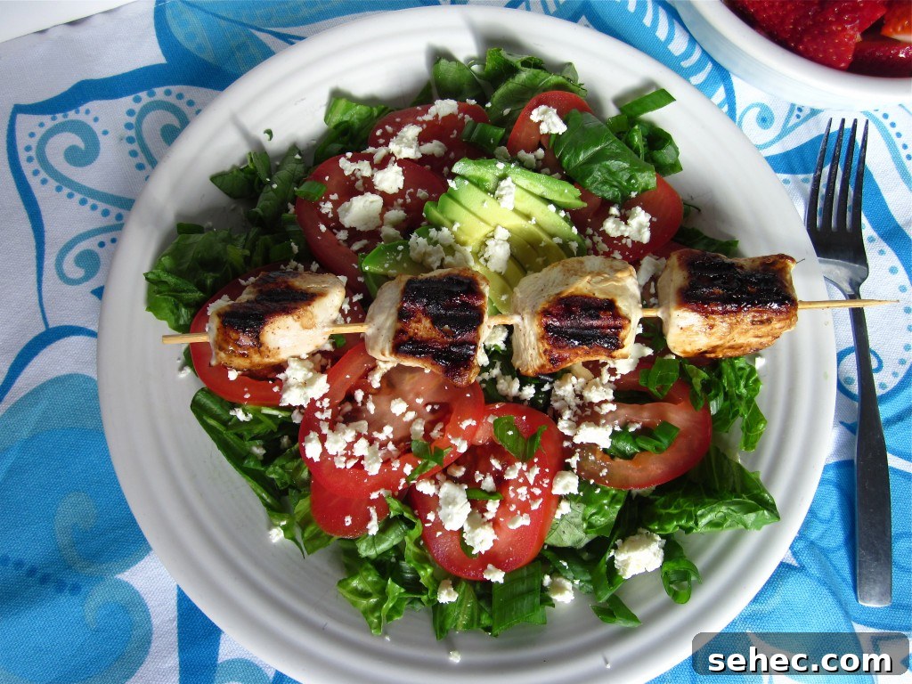 Chicken Kebab Salad with Cucumber and Yogurt Dressing 3 Yogurt marinated chicken kebabs on skewers