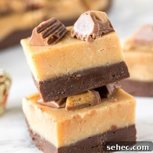 2 pieces of layered chocolate peanut butter fudge stacked on top of each other