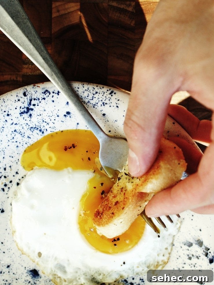 How to Fry an Egg Perfectly Every Time 7 Dipping into a runny yolk fried egg