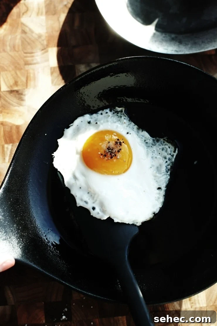 How to Fry an Egg Perfectly Every Time 8 Flip fried egg in cast-iron skillet to have an egg over easy