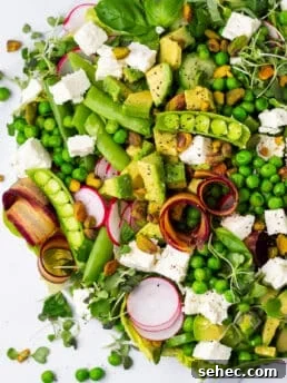 salad with spring peas, snap peas, radish, carrot, feta, avocado and cucumbers