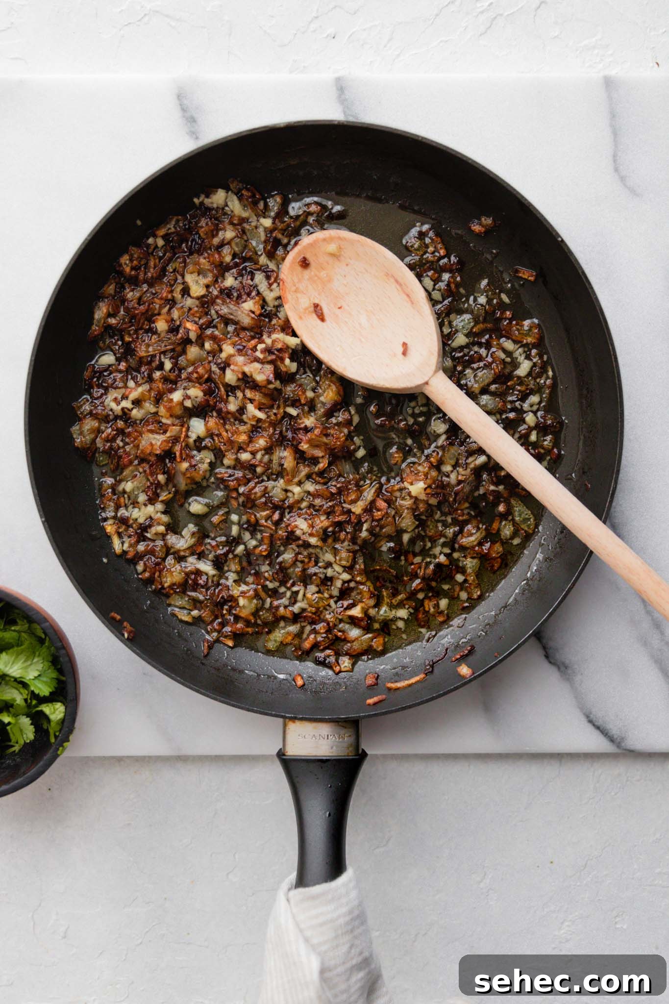 Sarson Ka Saag Recipe Stovetop and Instant Pot 11 Tadka or browned onions and minced ginger in a medium skillet ready to be mixed in with Sarson Ka Saag