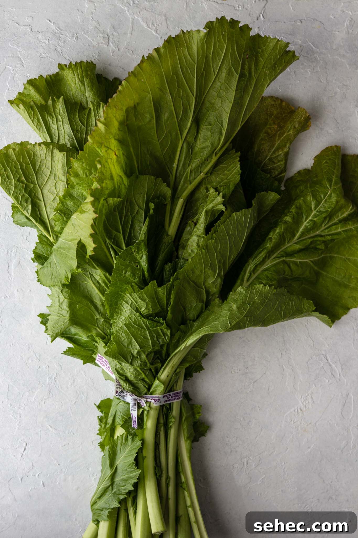 Sarson Ka Saag Recipe Stovetop and Instant Pot 13 One bunch of Mustard Greens on a white surface