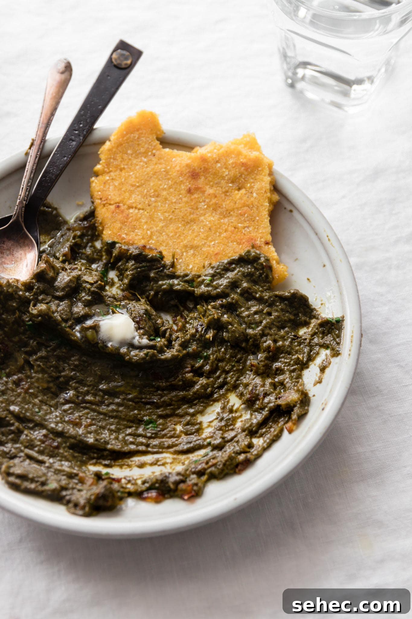 Sarson Ka Saag Recipe Stovetop and Instant Pot 15 Half eaten plate of Sarson Ka Saag served with Makai ki roti (cornmeal flatbread)
