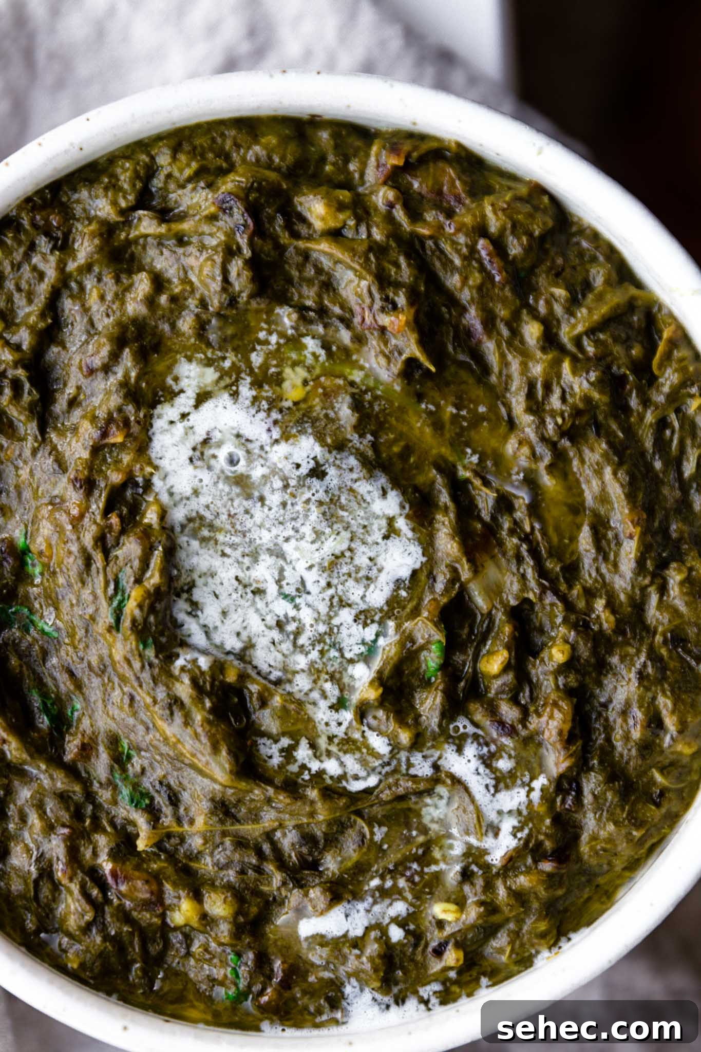 Sarson Ka Saag Recipe Stovetop and Instant Pot 3 Close up of Sarson Ka Saag with a dollop of melted butter