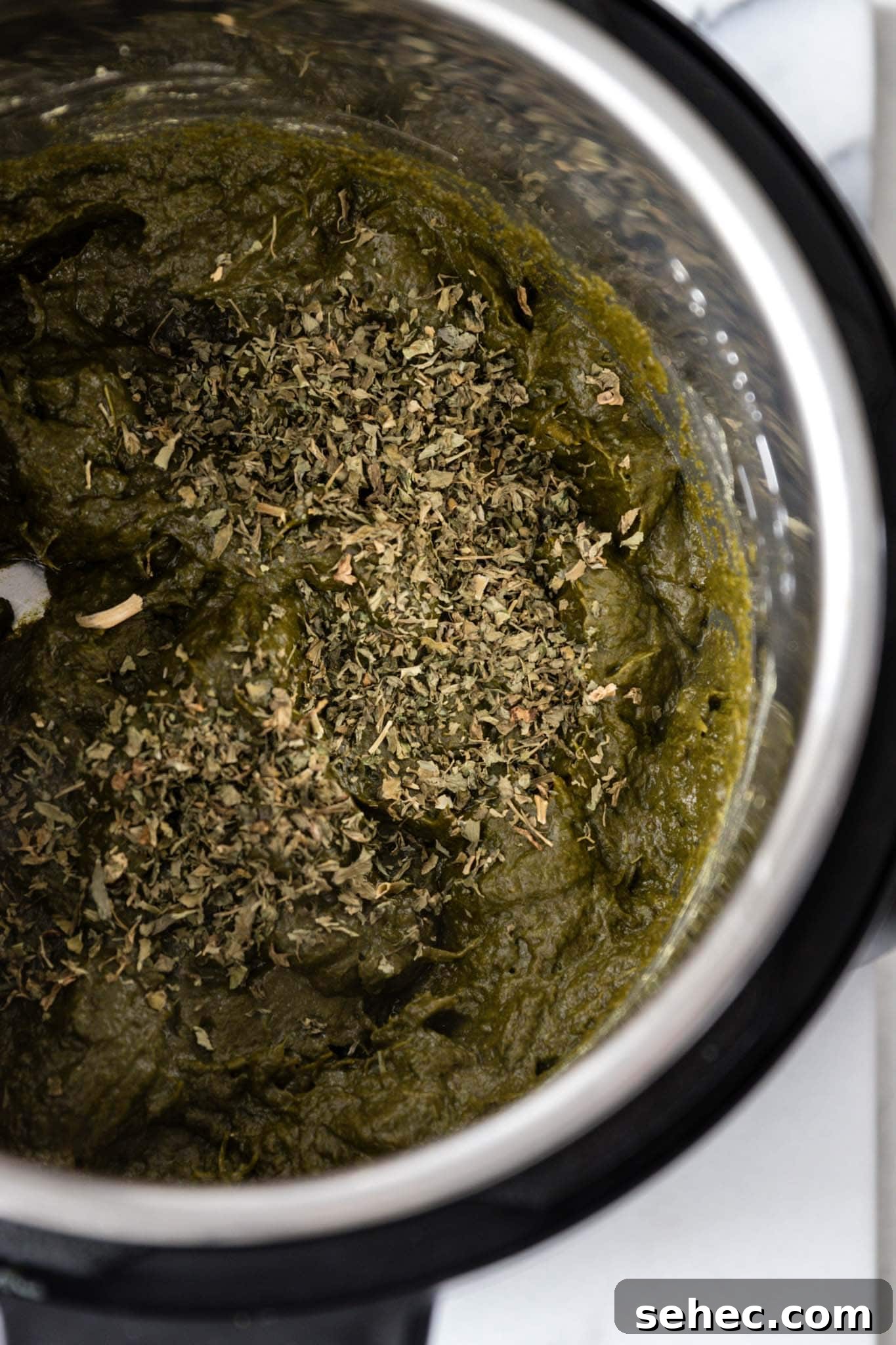 Sarson Ka Saag Recipe Stovetop and Instant Pot 10 Adding dried fenugreek leaves (methi) to the Instant Pot for Sarson Ka Saag