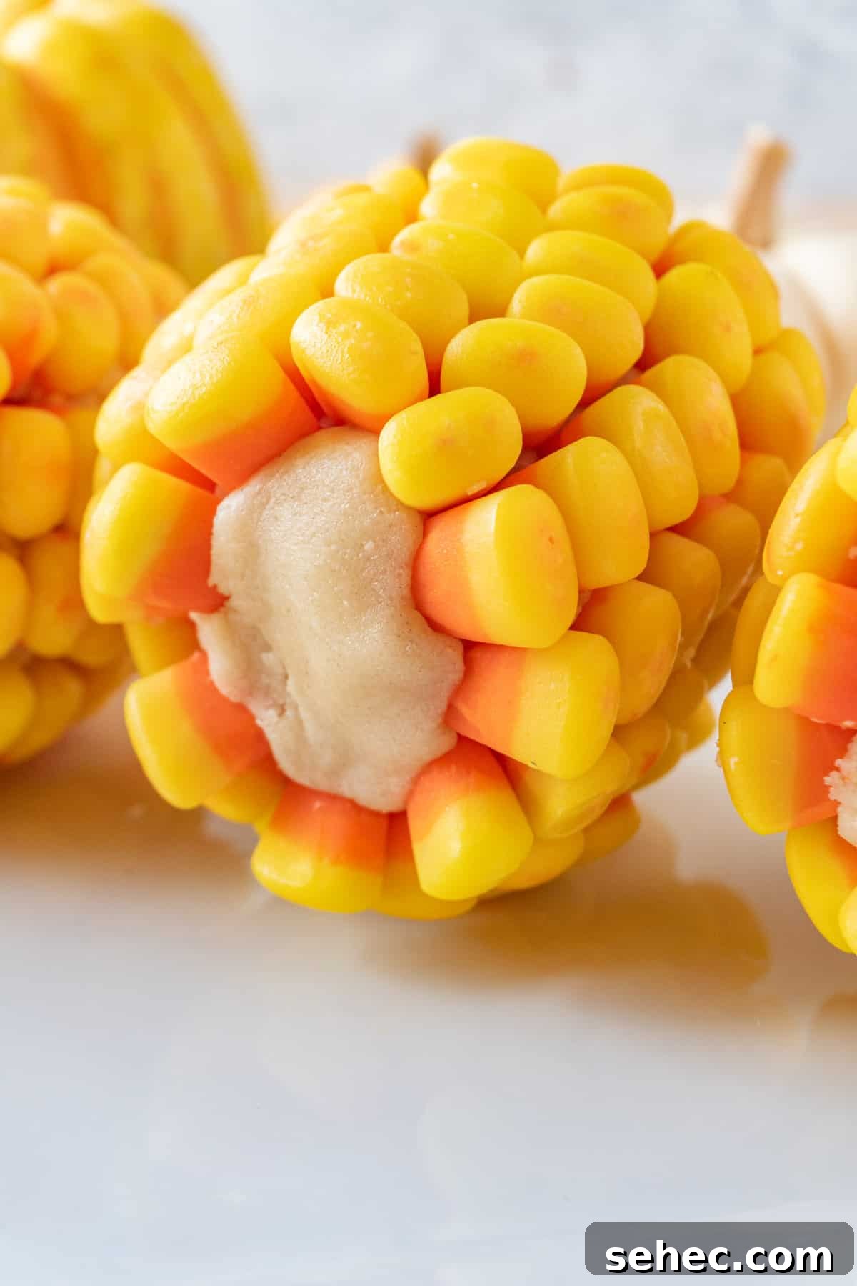 Candy Corn on the Cob Halloween Treats 2 candy corn on the cob on the side showing the sugar cookie center and beautiful candy corn kernels.
