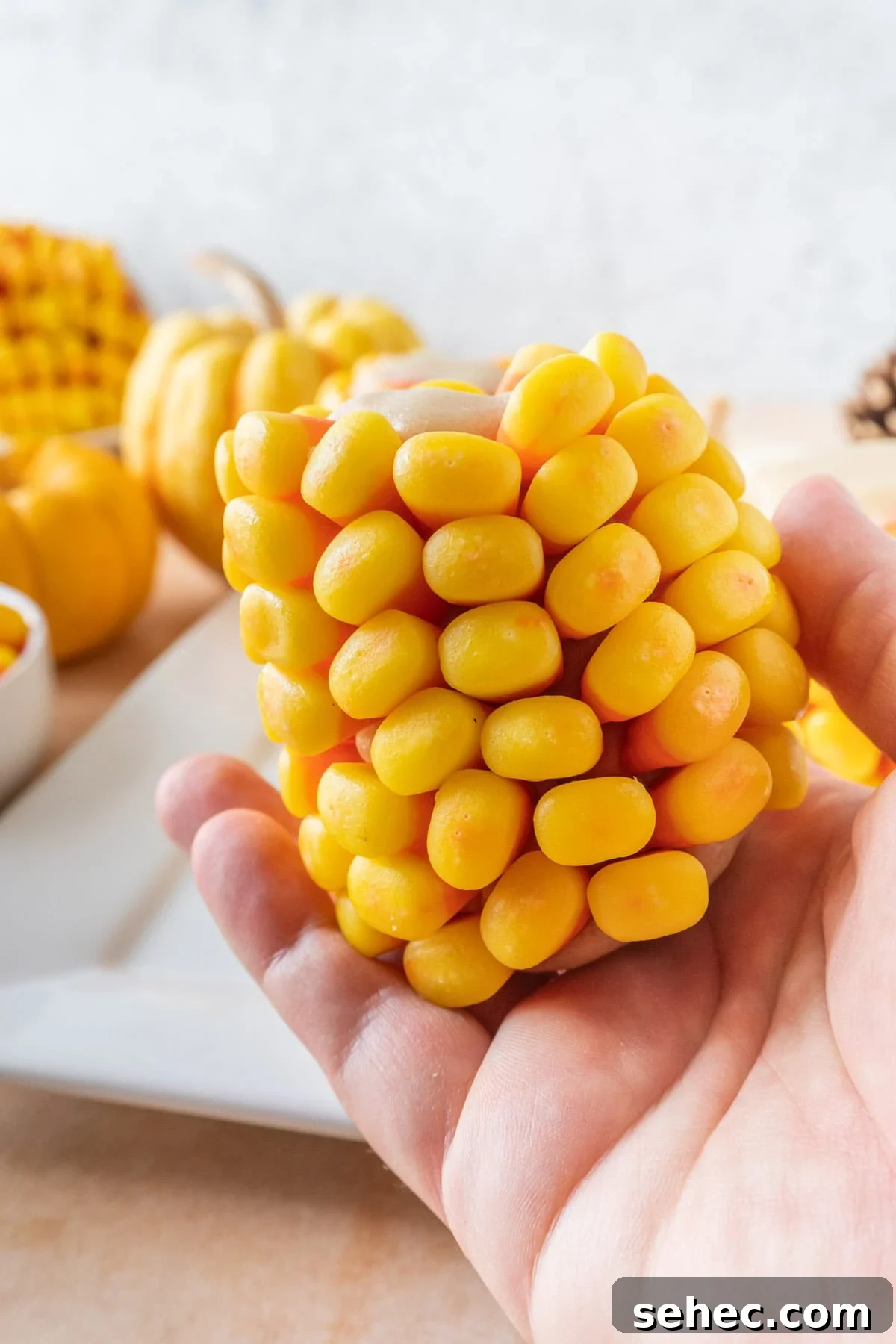 Candy Corn on the Cob Halloween Treats 12 Holding candy corn on the cob, showing the side and all the kernel rows.