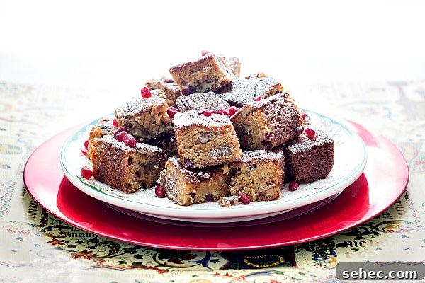 Christmas Sorghum Blondies with Pomegranate and Pecans 3 A plate of blondies all stacked up.