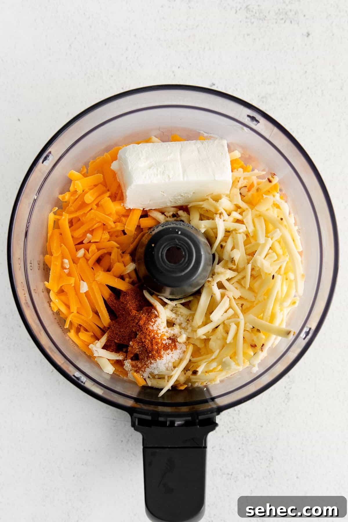 Cheese spread ingredients in a food processor. Ingredients for homemade cheese spread in a food processor.