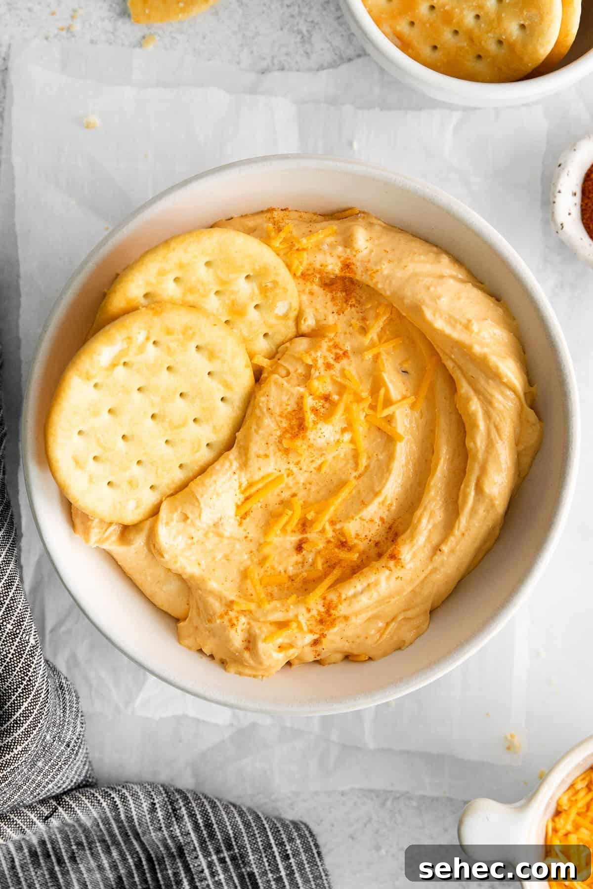 Homemade cheese spread served with crackers. Homemade cheese spread in a bowl with crackers.