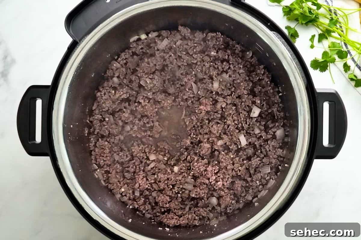 Beef and Bean Chili Instant Pot Ground beef and onion sauteed inside Instant Pot.