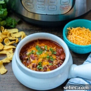 Instant Pot Chili Recipe 2 Bowl of Instant Pot Beef and Bean chili next to instant pot.