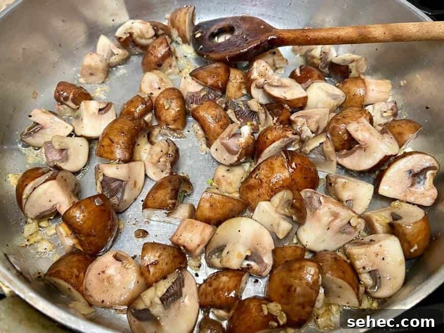 Julia Child Beef Bourguignon Recipe Made Simple 12 Sauteing mushrooms in a pan, stirring with a wooden spoon.