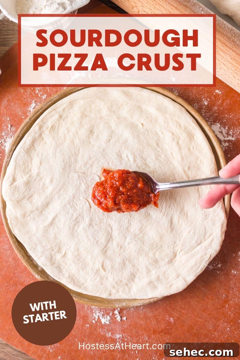 Crispy Chewy Sourdough Pizza Crust Recipe 18 Pizza sauce being spread onto homemade sourdough pizza crust