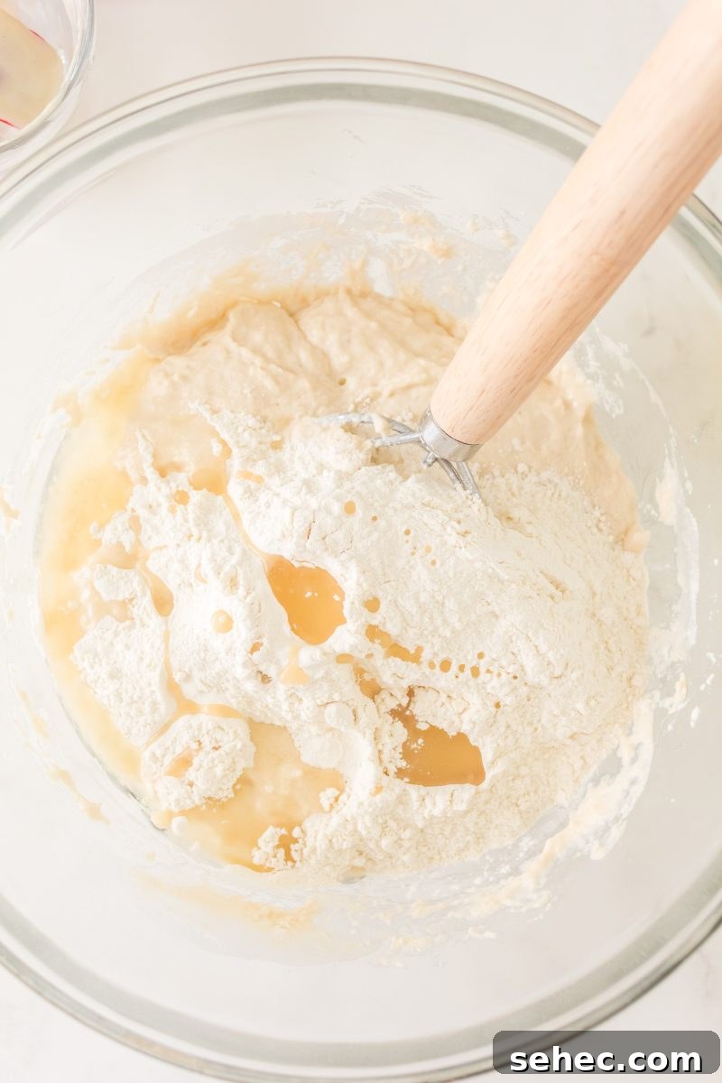 Crispy Chewy Sourdough Pizza Crust Recipe 6 Mixing bowl filled with starter, water, and flour