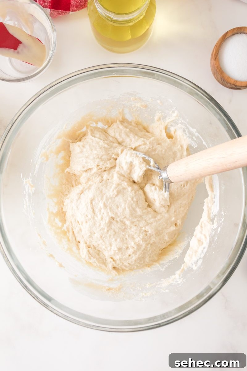 Crispy Chewy Sourdough Pizza Crust Recipe 7 Sticky sourdough pizza dough in a mixing bowl