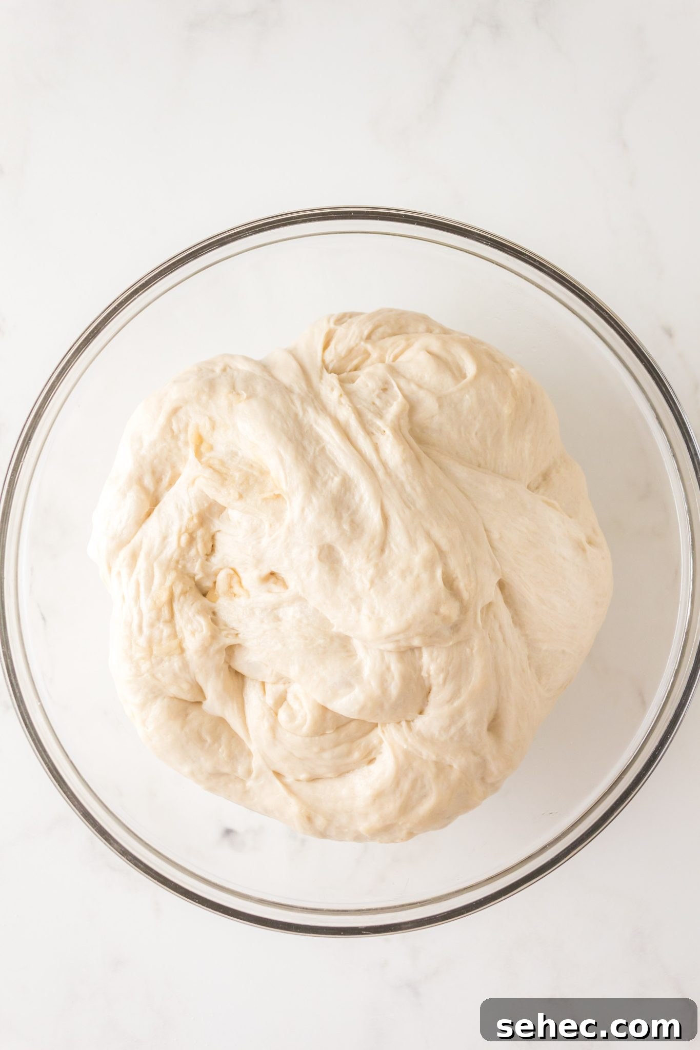 Crispy Chewy Sourdough Pizza Crust Recipe 10 A bowl of soft sourdough pizza dough