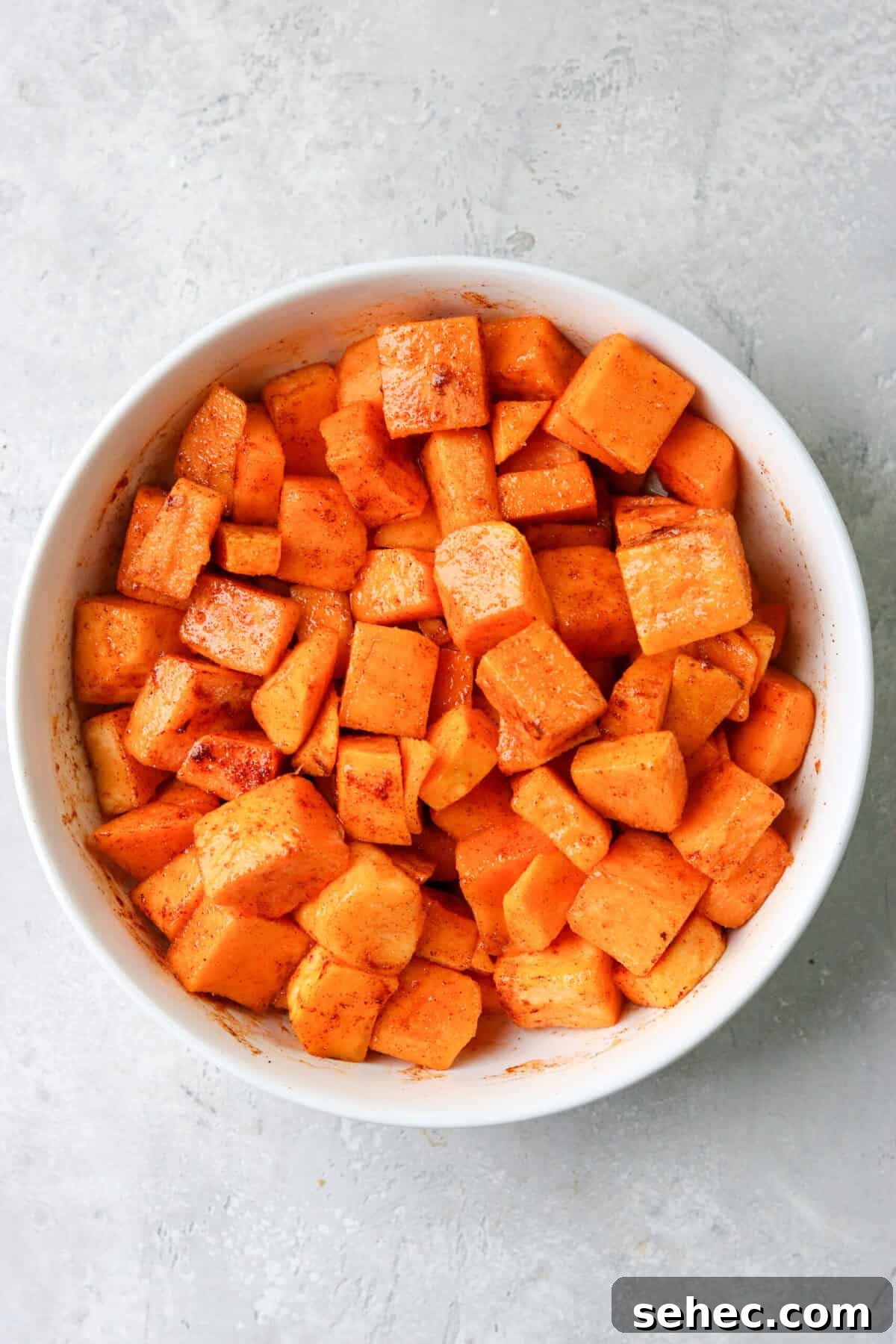Air Fryer Butternut Squash with Oven Baked Option 4 butternut squash in a white bowl