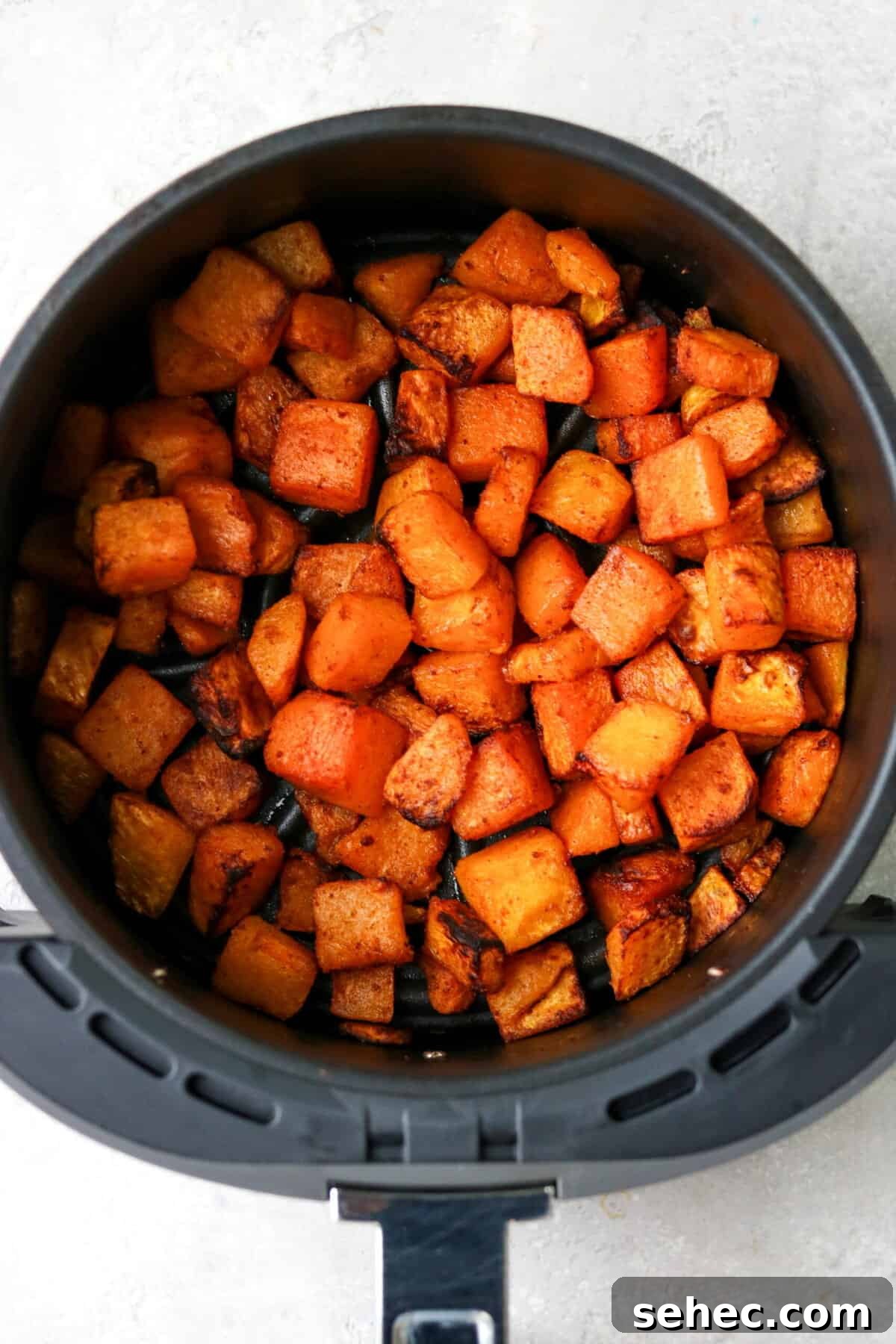 Air Fryer Butternut Squash with Oven Baked Option 6 cooked butternut squash in an air fryer basket