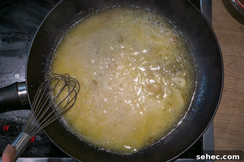 Creamy Lemon Pasta Recipe Without Cream 5 Whisking in the parmesan cheese
