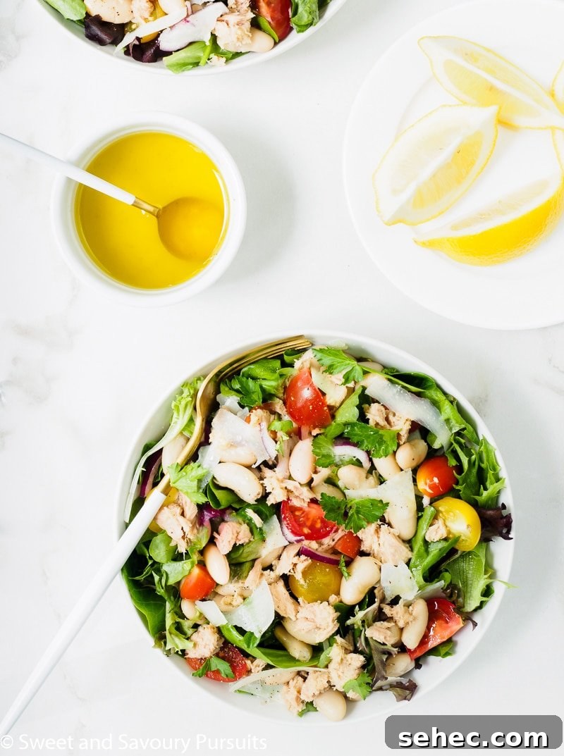Mediterranean White Bean and Tuna Salad 5 A bowl of white bean and tuna salad served with lemon and olive oil dressing on the side.