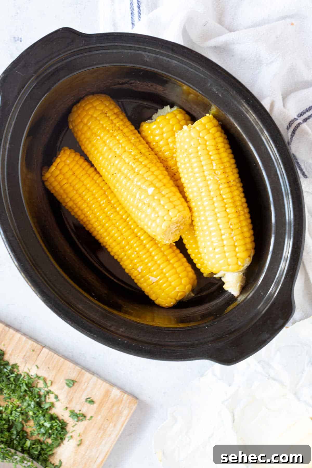 Slow cooker corn in a black slow cooker basin.