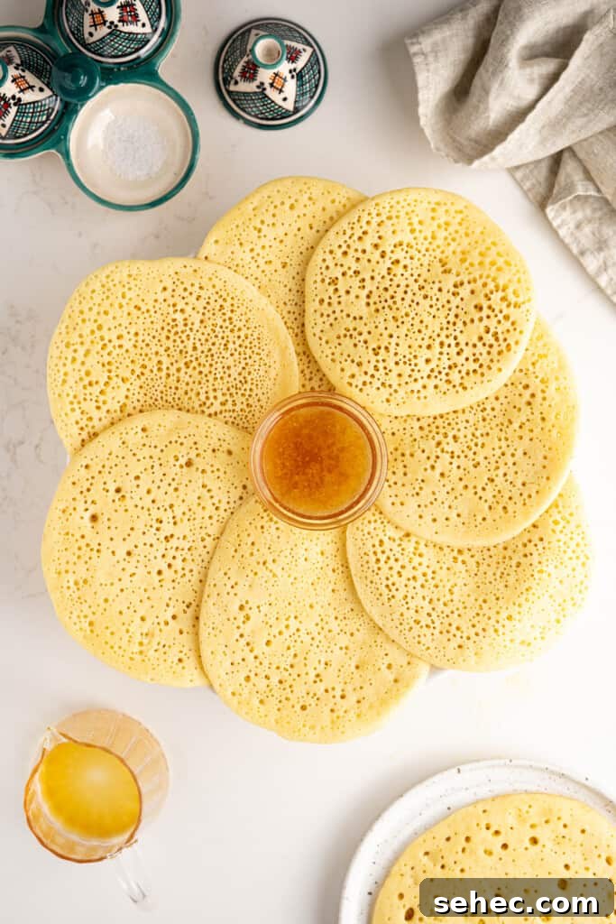 Baghrir Moroccan Semolina Pancakes with Honeycomb Holes 9 moroccan pancakes on a platter with honey