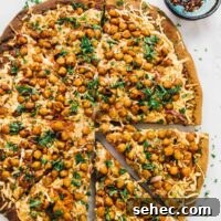 Vegan BBQ Chickpea Pizza with Spicy Sauce 2 Overhead view of whole spicy BBQ chickpea pizza with two slices pulled away slightly